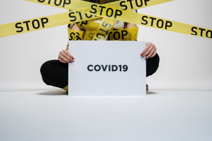 person-holding-covid-sign-3951600.jpg